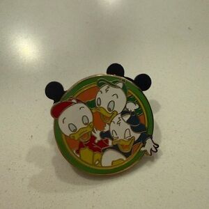 Disney Duck Trio Pin with Green and Orange Accents